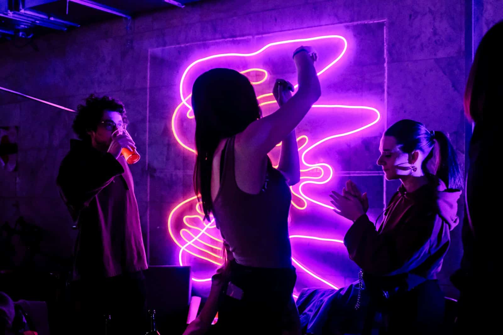 woman in black tank top singing on stage